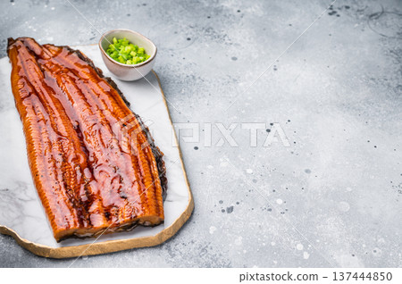 Unagi eel, Japanese grilled fish fillet of eel with sauce. grey background. top view Unagi eel, Japanese grilled fish fillet of eel with sauce. grey background. top view 137444850