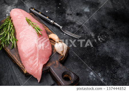 Raw turkey breast fillet meat, fresh poultry steak ready for cooking. black background. top view Raw turkey breast fillet meat, fresh poultry steak ready for cooking. black background. top view 137444852