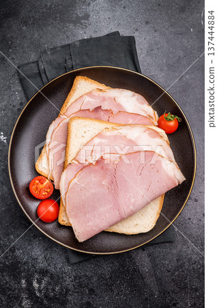 Ham sandwich, toast with sliced Prosciutto Cotto. black background. top view Ham sandwich, toast with sliced Prosciutto Cotto. black background. top view 137444884
