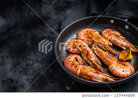 Pan fried red Argentine shrimps, Prawns Langostino Austral with herbs. black background. top view 137444889