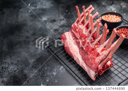 Raw rack of lamb, fresh mutton meat for chops cutlets. black background. top view Raw rack of lamb, fresh mutton meat for chops cutlets. black background. top view 137444890