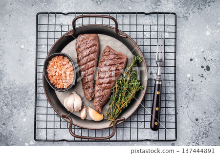 Grilled Mutton tenderloin fillet steak, lamb meat with herbs. grey background. top view 137444891