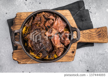 Red Wine Braised Beef Cheek meat with Creamy sauce in a skillet. grey background. top view Red Wine Braised Beef Cheek meat with Creamy sauce in a skillet. grey background. top view 137444893