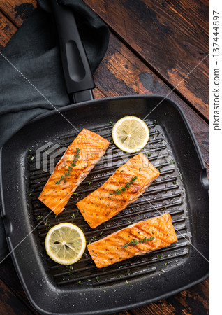 Pan fried salmon fillet steaks with thyme and lemon, fresh fish. wooden background. top view 137444897