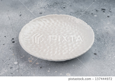 Top view blank ceramic plate with patterned surface, modern minimalist tableware concept ideal for restaurant branding or food styling Top view blank ceramic plate with patterned surface, modern minimalist tableware concept ideal for restaurant branding or food styling 137444972