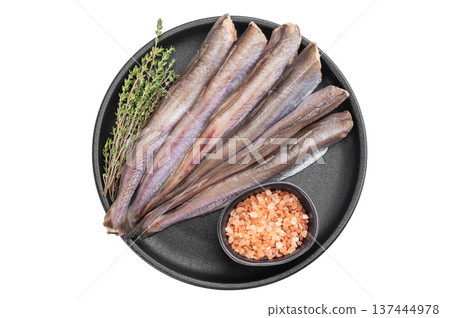 Uncooked blue whiting seafood arranged on isolated background, silver ocean fish similar to hake and codling, clean culinary composition with herbs and seasoning 137444978