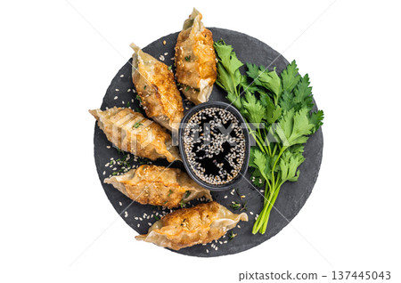 Fried Gyoza on plate with sauce, Japanese Dumplings with shrimps and vegetables isolated on white background. top view Fried Gyoza on plate with sauce, Japanese Dumplings with shrimps and vegetables isolated on white background. top view 137445043