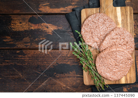 Vegan meatless burger patties plant based protein substitute for vegetarian and flexitarian diet dark background top view Vegan meatless burger patties plant based protein substitute for vegetarian and flexitarian diet dark background top view 137445090