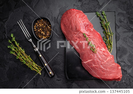 Uncooked beef tenderloin prepared with herbs. High quality meat perfect for oven roasting roast beef or elegant steak dishes. 137445105