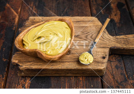 Gourmet pistachio cream with silky texture flat lay overhead view clean wooden background confectionery ingredient 137445111