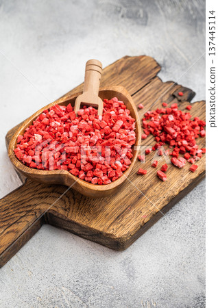 Crunchy freeze dried strawberry pieces used as topping and baking ingredient. Rustic food flatlay with copy space 137445114