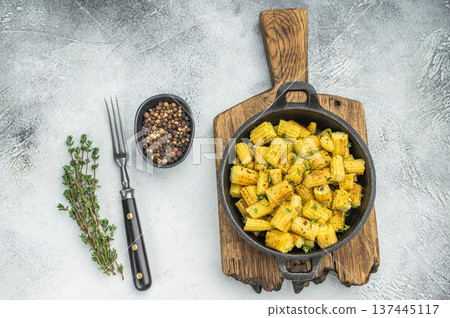 Cooked baby corn vegetable fried until crispy served in pan with herbs healthy plant based food concept 137445117