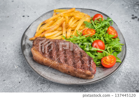 Juicy grilled beef culotte steak with potatoes and arugula salad, sirloin cap cut served for lunch or dinner 137445120