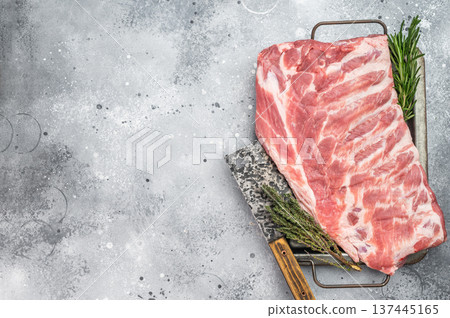 Raw pork ribs rack on gray background fresh meat on bone butcher cut studio food photography Raw pork ribs rack on gray background fresh meat on bone butcher cut studio food photography 137445165