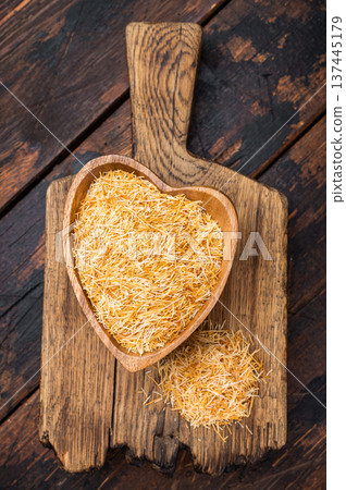 Shredded phyllo kataifi dough used for sweet pastries and desserts. Rustic overhead composition with copy space Shredded phyllo kataifi dough used for sweet pastries and desserts. Rustic overhead composition with copy space 137445179