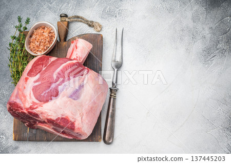Fresh raw beef shank knuckle whole cut with bone styled with thyme and salt copy space on stone background ingredient for ossobuco 137445203