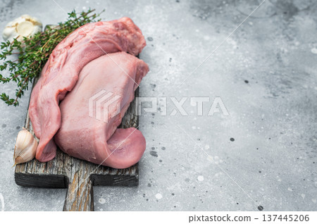 Whole uncooked lamb tongue displayed with herbs spices and vintage fork on light stone background perfect for cuisine prep and food photography Whole uncooked lamb tongue displayed with herbs spices and vintage fork on light stone background perfect for cuisine prep and food photography 137445206