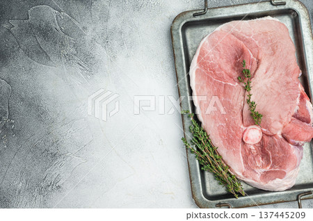 Uncooked pork shoulder whole piece with bone on tray isolated on grey background raw pink meat ingredient for roasting braising stew 137445209