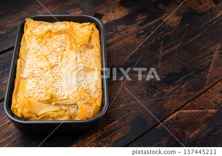Mediterranean phyllo pie with spinach and cheese filling, crispy golden layers and copy space Mediterranean phyllo pie with spinach and cheese filling, crispy golden layers and copy space 137445211
