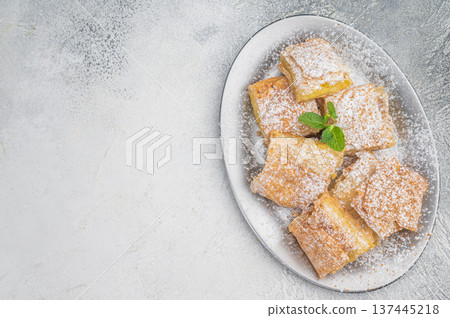 Traditional bougatsa style custard pastry with layered filo dough vanilla cream and mint garnish white background Traditional bougatsa style custard pastry with layered filo dough vanilla cream and mint garnish white background 137445218