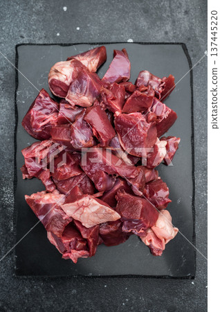 Fresh chopped pork heart pieces prepared for cooking, ideal for hearty stews, saute recipes and gourmet offal cuisine. Fresh chopped pork heart pieces prepared for cooking, ideal for hearty stews, saute recipes and gourmet offal cuisine. 137445220