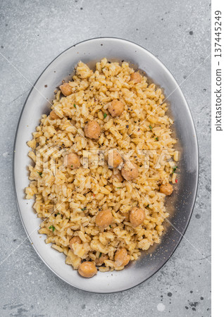 Turkish bulgur pilaf with chickpeas served in ceramic bowl top view on gray stone background with copy space 137445249