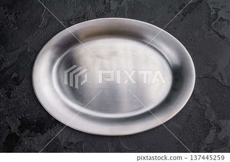 Silver metal platter overhead. Minimal oval stainless steel dish for restaurant and catering use 137445259