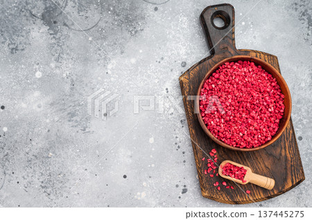 Freeze dried raspberry granules in wooden bowl with spoon on board. Vibrant berry ingredient flatlay with copy space Freeze dried raspberry granules in wooden bowl with spoon on board. Vibrant berry ingredient flatlay with copy space 137445275