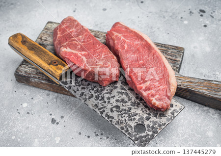 Raw beef culotte steaks also called picanha or rump cap with herbs and cleaver, premium meat on rustic wooden board 137445279