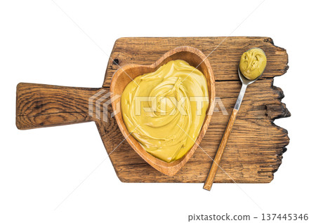 Sweet pistachio cream spread with rich green color served in wooden bowl minimal dessert concept on white background Sweet pistachio cream spread with rich green color served in wooden bowl minimal dessert concept on white background 137445346