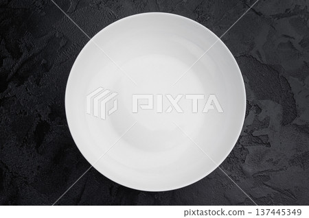 Minimal empty plate on dark background with texture. Modern ceramic tableware mockup with copy space Minimal empty plate on dark background with texture. Modern ceramic tableware mockup with copy space 137445349