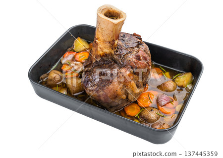 Slow cooked veal shank ossobuco style roasted with vegetables and gravy in baking tray on light background 137445359