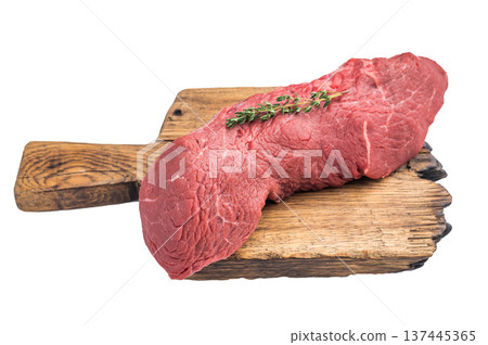 Fresh uncooked beef cut tenderloin with herbs on rustic board isolated on white background. Ideal ingredient for roast beef cooking. 137445365