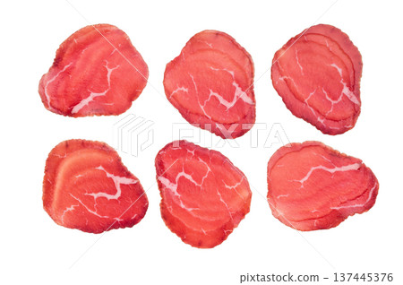 Thin sliced cured beef bresaola, rich red color and delicate marbling on clean white background. Thin sliced cured beef bresaola, rich red color and delicate marbling on clean white background. 137445376