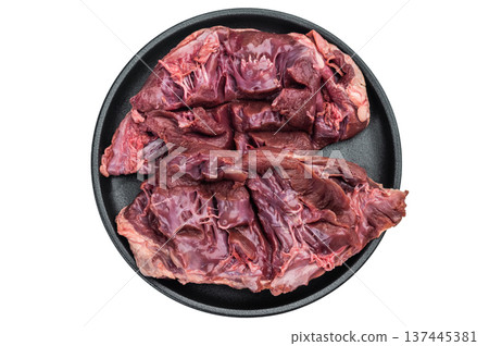 Raw lamb and goat hearts opened to show tender muscle layers ideal for stews braising and rustic nose to tail cooking. Raw lamb and goat hearts opened to show tender muscle layers ideal for stews braising and rustic nose to tail cooking. 137445381