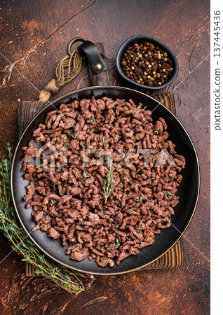 Fried mincemeat, cooked forcemeat in a plate. brown background. top view 137445436