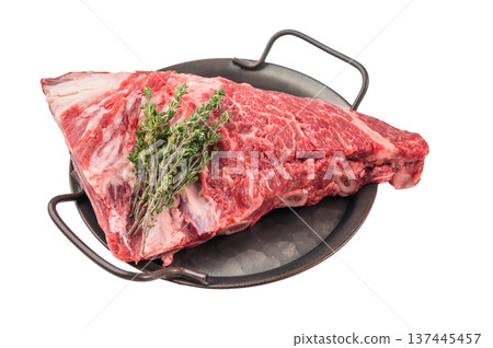 Raw beef shoulder meat with rich marbling in pan, herbs and garlic on isolated background. Protein rich steak for cooking. Raw beef shoulder meat with rich marbling in pan, herbs and garlic on isolated background. Protein rich steak for cooking. 137445457