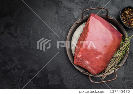 Uncooked beef liver served in cast iron dish. Fresh organ meat ingredient referred as veal calf liver. 137445470