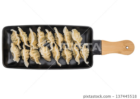 Soft pleated Asian dumplings with savory filling served on dark plate overhead shot great for stock images and menu design. Soft pleated Asian dumplings with savory filling served on dark plate overhead shot great for stock images and menu design. 137445518