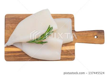 Fresh calamari tubes on a wooden board with rosemary on a bright white background perfect for seafood cuisine and cooking concepts. 137445524
