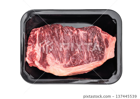 Prime New York strip steak in packaging on bright white surface, showcasing marbled beef cut for grilling, roasting or culinary content Prime New York strip steak in packaging on bright white surface, showcasing marbled beef cut for grilling, roasting or culinary content 137445539