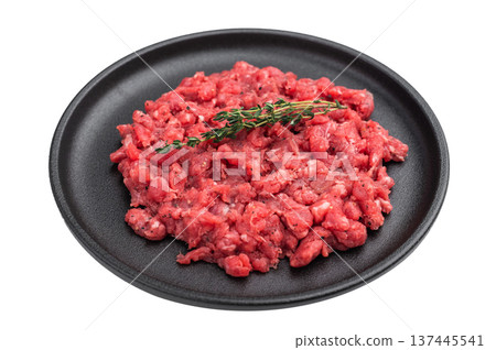 Fresh raw minced beef with thyme on a black plate over white background perfect for recipe layouts butcher themes and food stock images. Fresh raw minced beef with thyme on a black plate over white background perfect for recipe layouts butcher themes and food stock images. 137445541