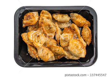 Golden pan fried dumplings jiaozi with sesame seeds, top view on light backdrop. Asian snack for restaurant design. Golden pan fried dumplings jiaozi with sesame seeds, top view on light backdrop. Asian snack for restaurant design. 137445547