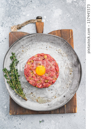 Fresh beef tartare with yolk on stone dish and wooden board great for gourmet cooking protein rich meals and high quality food photography. 137445573