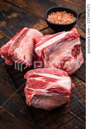 Thick Cut raw lamb Short Ribs, fresh mutton meat with bone. wooden background. top view Thick Cut raw lamb Short Ribs, fresh mutton meat with bone. wooden background. top view 137445673