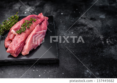 Raw sliced duck breast fillet, uncooked poultry meat. black background. top view Raw sliced duck breast fillet, uncooked poultry meat. black background. top view 137445682