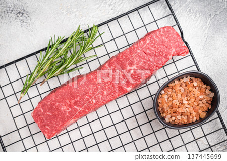 Premium Japanese wagyu beef steak, highlighting its tender texture and luxurious fat content. Ideal for those seeking a truly indulgent culinary experience. grey background. top view Premium Japanese wagyu beef steak, highlighting its tender texture and luxurious fat content. Ideal for those seeking a truly indulgent culinary experience. grey background. top view 137445699
