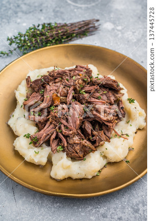 Homemade French Beef Bourguignon Stew on a plate with mashed potatoes. grey background. top view Homemade French Beef Bourguignon Stew on a plate with mashed potatoes. grey background. top view 137445728