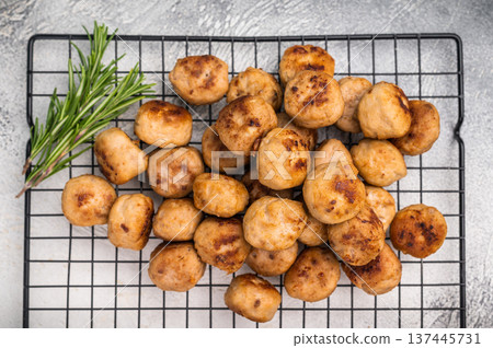 Fried Meatballs from beef and pork minced meat garnished with fresh herbs. grey background. top view 137445731