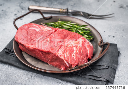 Freshly cut horse meat pieces arranged artfully, showcasing their tender texture and deep red hue, perfect for gourmet recipes. grey background. top view Freshly cut horse meat pieces arranged artfully, showcasing their tender texture and deep red hue, perfect for gourmet recipes. grey background. top view 137445736